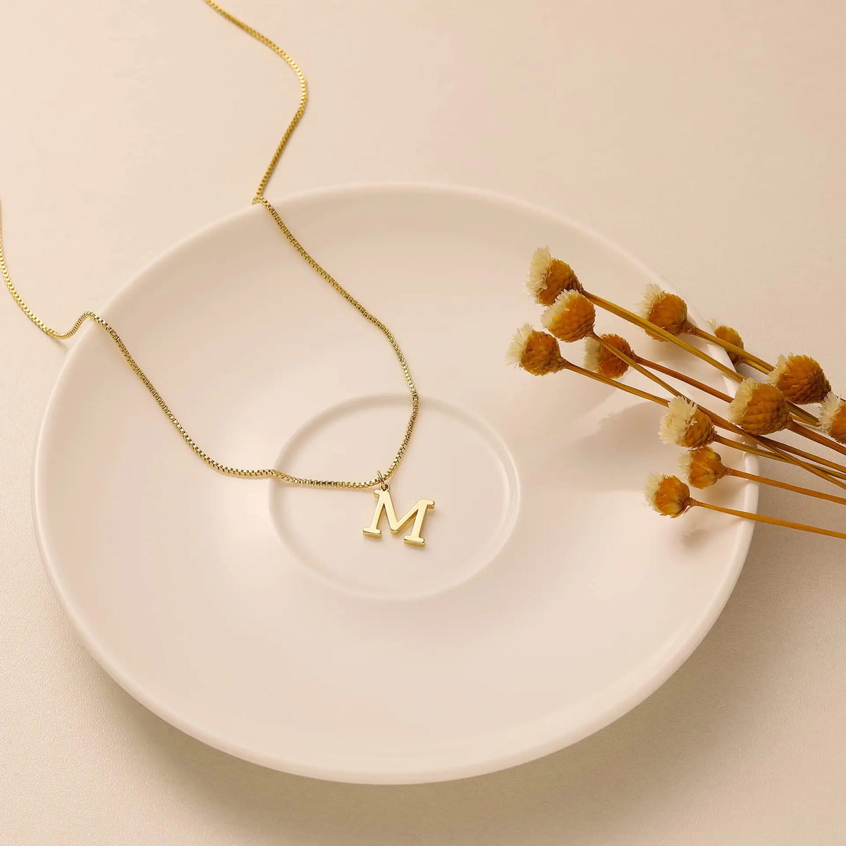 Gold letter necklace worn